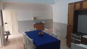 a kitchen with a blue table with chairs and a stove at Gira Lua in Igreja +49 photos