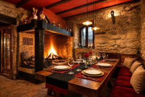a dining room with a table and a fireplace at Fortaleza Medieval La Manyosa in Granera