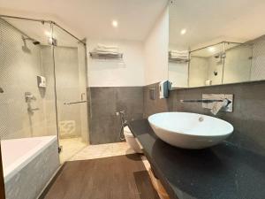 a bathroom with a sink and a tub and a toilet at Hotel Royal Serena in Ambāla +26 photos