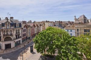 a view of a city with buildings and a tree at Haussmannien calme hyper-centre in Troyes