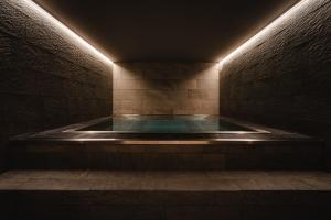 a jacuzzi tub in a dark room with lights at St Elisabeth Hotel & Spa in Tromsø