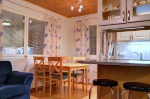 a kitchen and dining room with a table and chairs at Alppitalo 2 as 1 in Tahkovuori