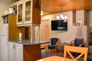 a small kitchen with a table and a dining room at Alppitalo 2 as 1 in Tahkovuori +2 photos