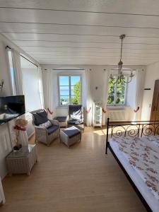 a living room with a bed and a couch at Irseer Hof in Hagnau in Hagnau
