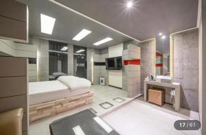a bedroom with a bed and a sink in it at 로미오앤줄리엣 in Daegu +8 photos