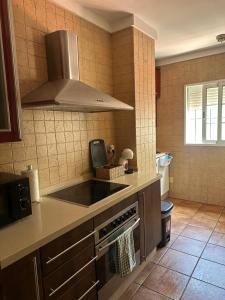 a kitchen with a stove top oven in a kitchen at Apartamento en Huelva. in Huelva
