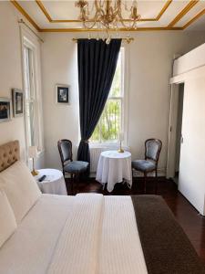 a bedroom with a bed and two chairs and a window at No16 Ada in Adalar