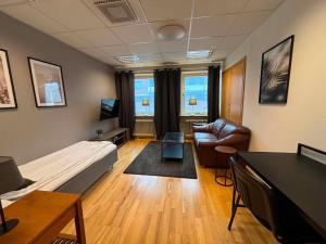 a room with a bed and a couch and a table at Vannebodagatan in Frövi