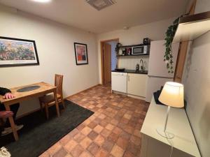 a kitchen and dining room with a table and a refrigerator at Vannebodagatan in Frövi