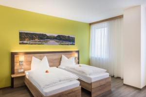 
Ein Bett oder Betten in einem Zimmer der Unterkunft Sleepin Premium Motel Loosdorf
