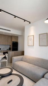 a living room with a couch and a table at Penthouse-AH- 77 in Eilat +17 photos