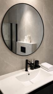 a bathroom sink with a large mirror above it at Penthouse-AH- 77 in Eilat
