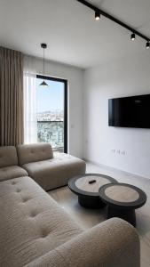 a living room with a couch and a table at Penthouse-AH- 77 in Eilat