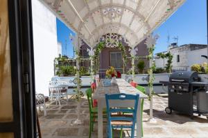 a patio with a table and chairs under a pergola at Casa del Conte in Parabita
