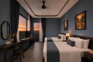 a hotel room with two beds and a desk at Lumina Premium- HT Boutique 2 - Đống Đa in Da Lat +52 photos