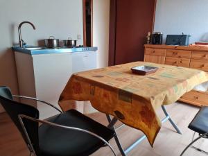 a wooden table and chairs in a kitchen with a sink at Drachenfels Nest in Königswinter