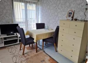 a dining room with a table and chairs and a dresser at Drachenfels Nest in Königswinter