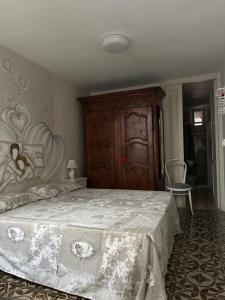 a bedroom with a large bed with a white blanket at Casa del Conte in Parabita