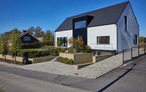 a large white house with a black roof at Vakantiewoning Belle Vue in Hooglede