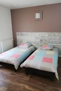 two beds sitting next to each other in a bedroom at Le roqual in Carsac-Aillac +22 photos