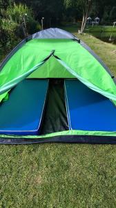 a green tent on the grass in a field at Camping Mairiporã in Mairiporã +7 photos