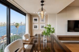 a dining room with a glass table and white chairs at The Nile Residence in Cairo