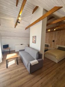 a living room with a couch and a bed at Vila Varėna in Varėna