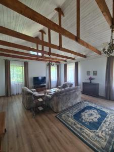 a living room with a couch and a table at Vila Varėna in Varėna