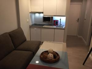 a living room with a couch and a kitchen at Apartamento en Sierra Nevada in Sierra Nevada