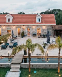 a house with a pool and palm trees in front of it at Lourença Stays - Quinta Lourença in Vilar