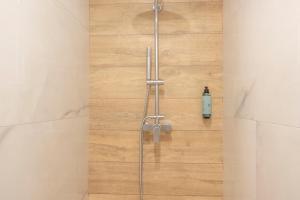 a shower in a bathroom with a wooden floor at Next to the wave in Myrties +53 photos