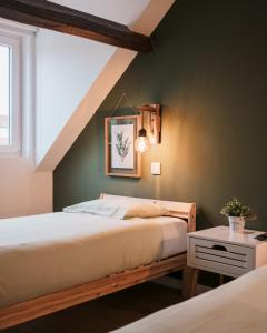 two beds in a bedroom with green walls at Lourença Stays - Quinta Lourença in Vilar