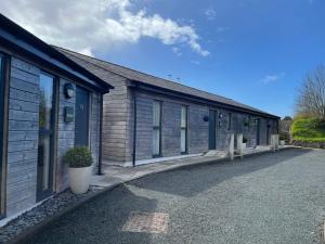 a row of buildings with a lot of windows at Umber, Gallery Cottages, Devon in West Putford
