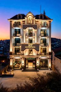 a large white building with lights on it at Lumina Premium- HT Boutique 2 - Đống Đa in Da Lat