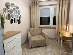 a living room with a chair and a window at Urban Relax AC Progres in Toruń