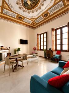a living room with a couch and a table at Palazzo Bolasco in Alghero