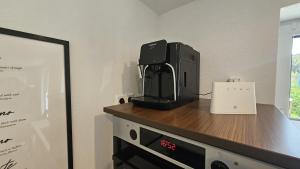 a black appliance sitting on top of a counter at Schwarzwald Lodge Schonach in Schonach +15 photos