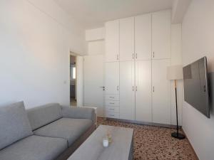a living room with a couch and a table at Paroikia Sunset in Kampos Paros
