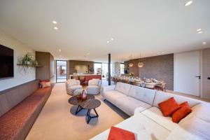 a living room with a couch and a table at Vakantiewoning Belle Vue in Hooglede