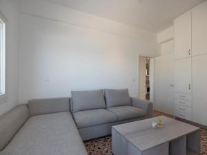 a living room with a couch and a coffee table at Paroikia Sunset in Kampos Paros +35 photos