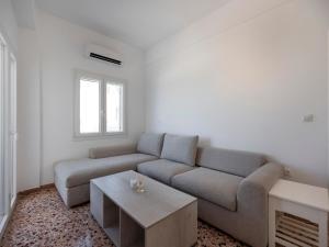 a living room with a couch and a coffee table at Paroikia Sunset in Kampos Paros