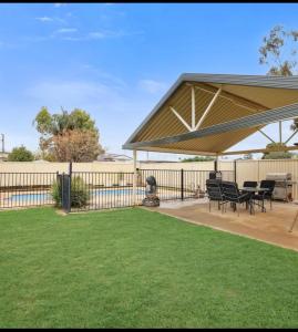 a pavilion with chairs and tables in a yard at Taking 5 in West Tamworth