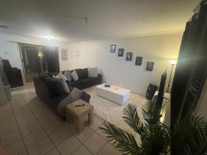 a living room with a couch and a coffee table at Taking 5 in West Tamworth