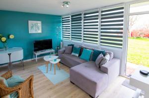 a living room with a couch and a table at The Retreat Camber in Camber