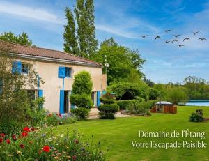 a house in a garden with birds flying above it at Au Lit D'Ô in Bressuire