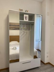 a large white cabinet in a room with a bed at Fortezza in Bellinzona