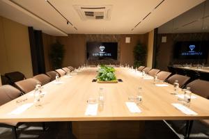 a large conference room with a long table with chairs at Sapphire Hotel in Prizren