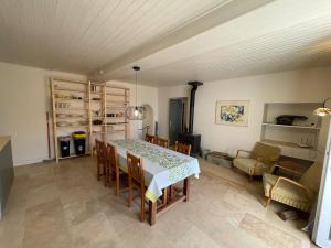 a dining room with a table and chairs at La ferme Bourguignonne in Saizy