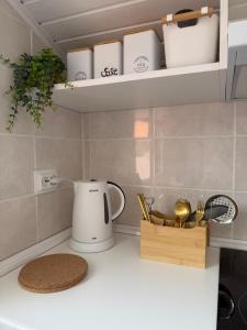 a kitchen counter with a coffee pot and utensils at Meu Quintal 3, Calheta-Madeira in Calheta +12 photos