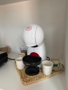 a coffee maker on a tray with cups on it at Meu Quintal 3, Calheta-Madeira in Calheta